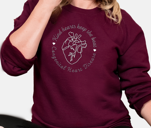 Person wearing a maroon sweatshirt with a heart design and text.